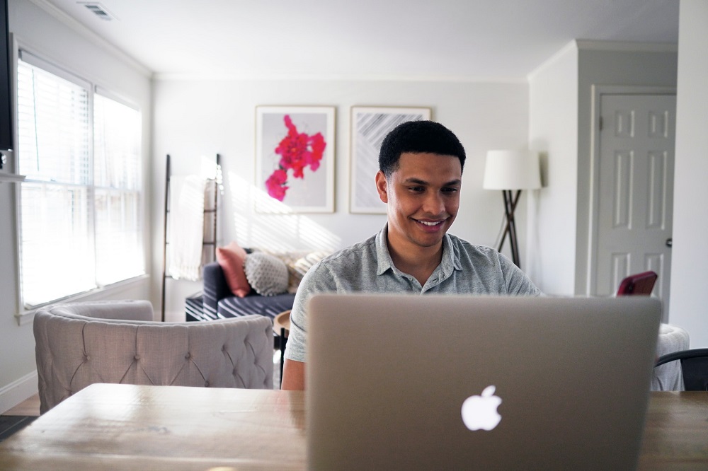 Man smiling at computer