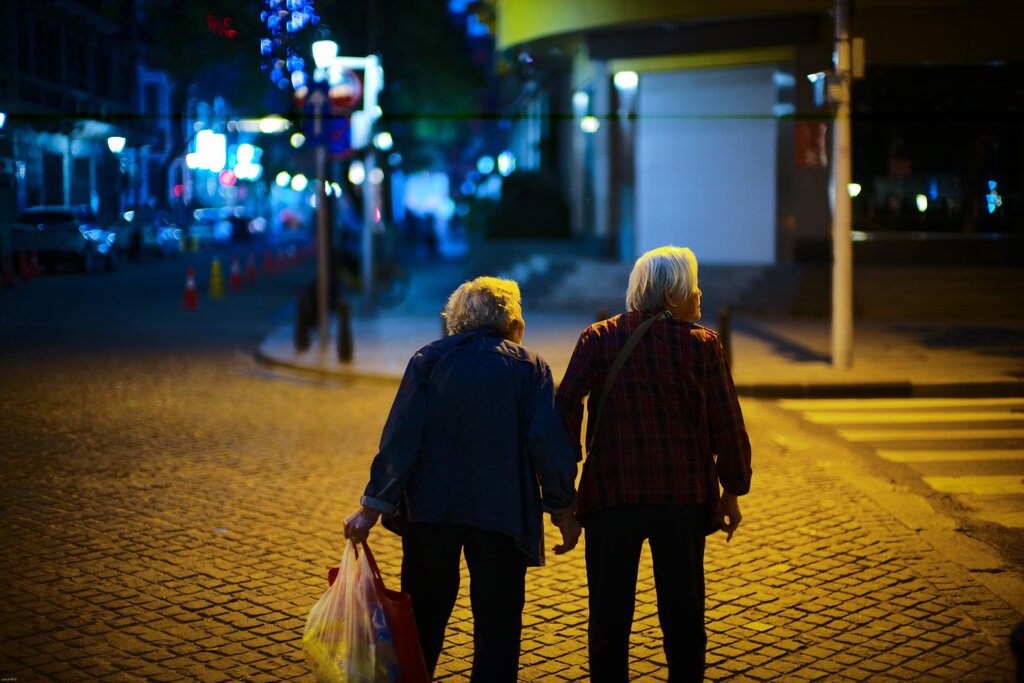Elderly ladies crossing a street