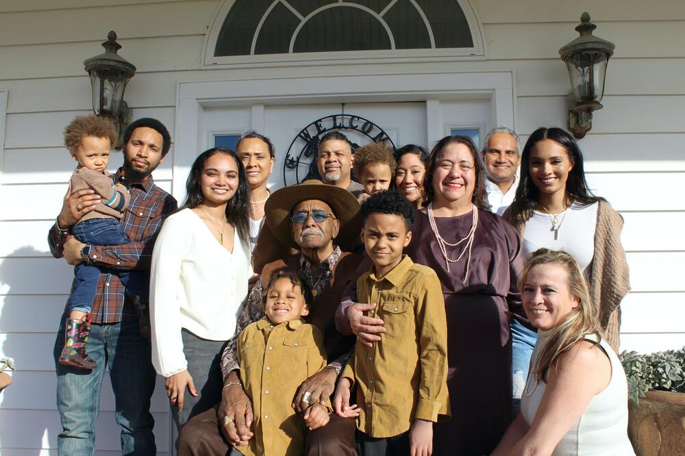 Large extended family in front of front porch