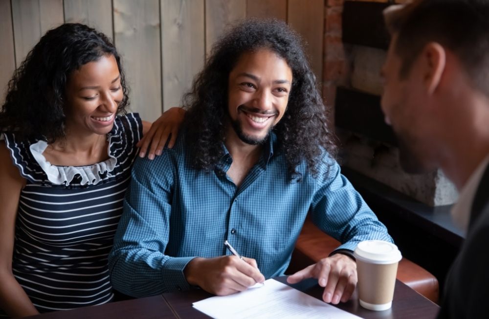 Happy man signing document