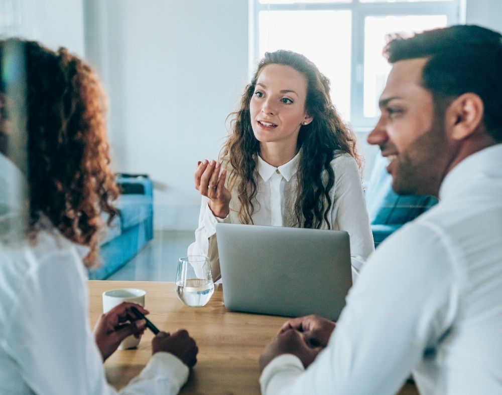 Colleagues at table in discussion