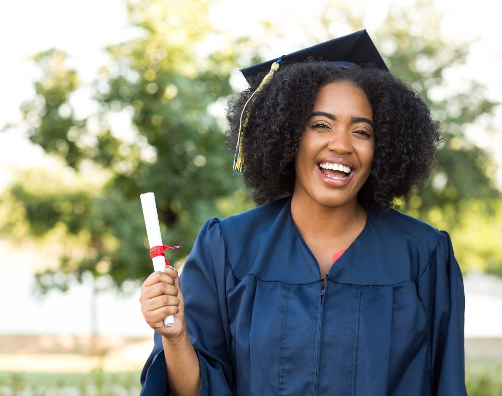 Female graduate holding degree scroll