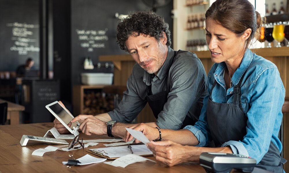 two people in business talking about tax